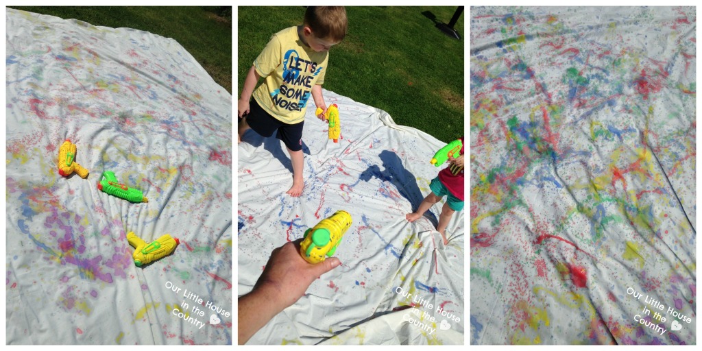 Painting with Water Pistols - More Messy Outdoor Summer Art Fun! - Our Little House in the Country #waterguns #waterpistols #summer #kidsactivities #artforkids